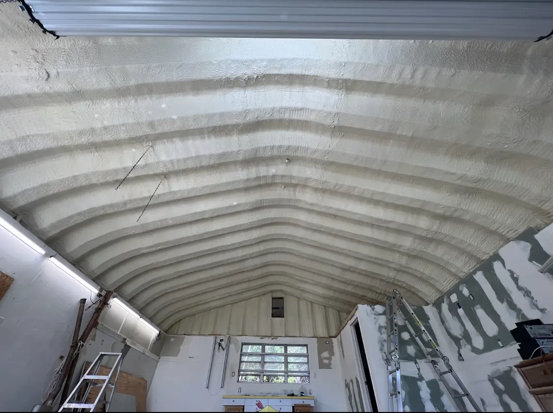 Spray polyurethane foam applied to the underside of a metal roof deck in Progreso